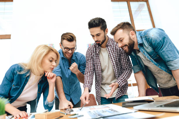 istock Team of designers architects look at floor layout. 955045382