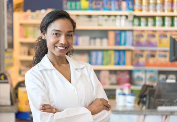 istock Confident black female pharmacist looking at camera smiling with arms crossed 955049968