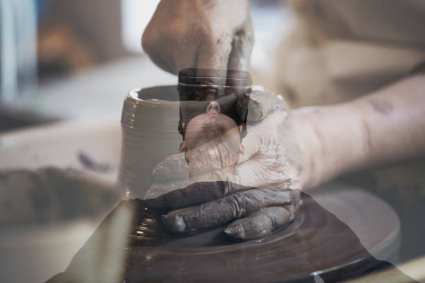 istock Man wearing a virtual reality headset enjoying pottery in a virtual reality world 955054036