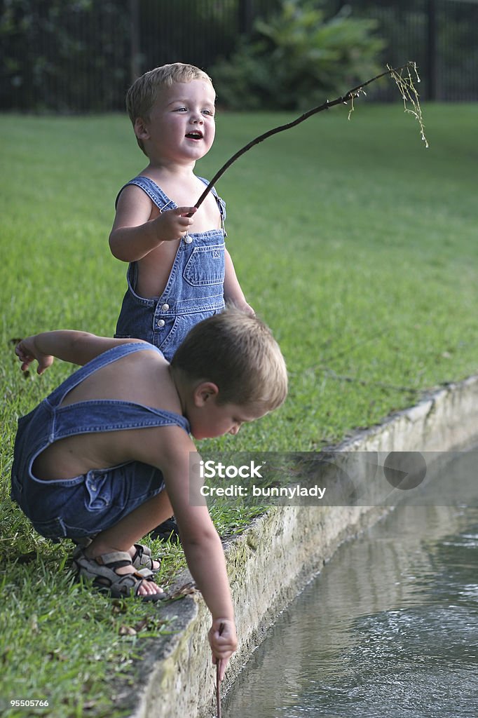 Fishing by the lake:  I caught one!  At The Edge Of Stock Photo