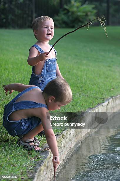 Fishing By The Lake I Caught One Stock Photo - Download Image Now - At The Edge Of, Bib Overalls, Blue