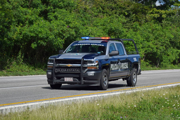 Chevrolet police car on the highway Cancun, Mexico - 11 January, 2018: Chevrolet Silverado police car driving on the highway. This model is popular pick-up in Mexican police forces. chevrolet silverado stock pictures, royalty-free photos & images
