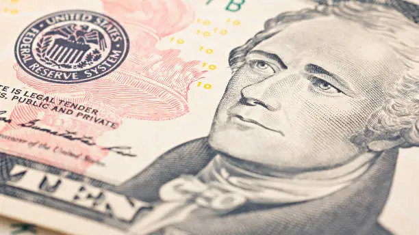 Photo of Closeup American money  twenty dollar bill. Alexander Hamilton portrait, US 10 dollar banknote fragment macro