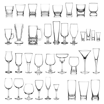 Large group of a variety of glasses isolated on white background. Composite image.