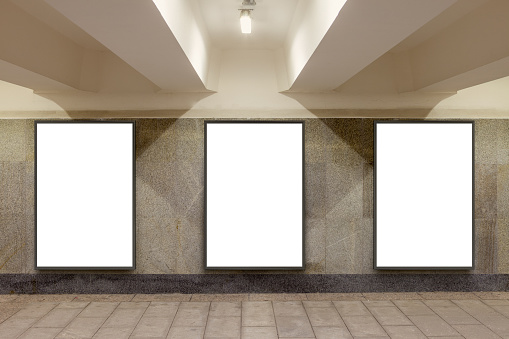 Three blank billboard advertisement posters on underground wall. 3d illustration