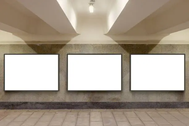 Three blank billboard advertisement posters on underground wall. 3d illustration