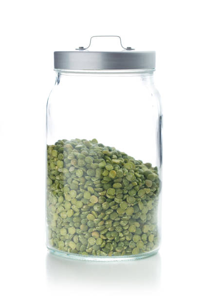istock Green split peas in jar isolated on white background. 955062456