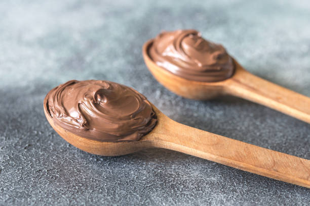 istock Two wooden spoons of chocolate cream 955065712