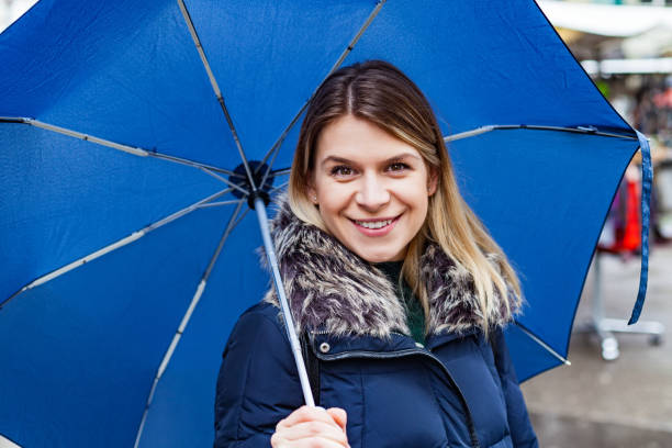 istock Woman with blue umbrella 955070234
