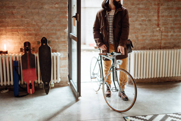 istock Close up of a man entering office with bicycle 955080214