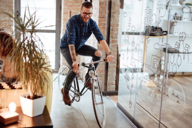 istock Happy young man cycling in a startup 955083048