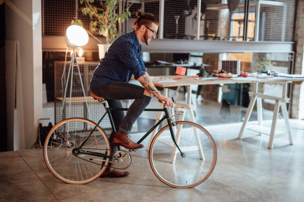 istock Happy young man cycling in a startup 955083082