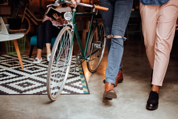 Employees walking with bicycle through the office