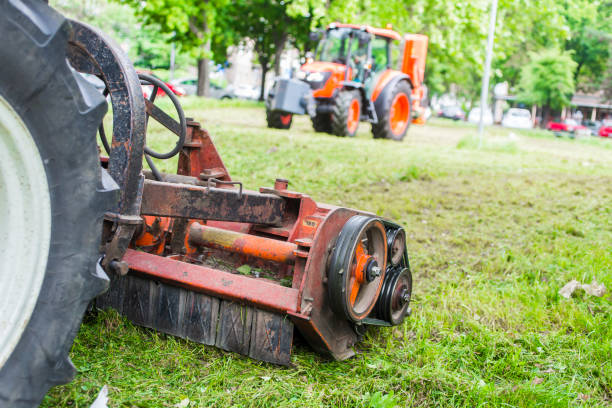 istock Tractor with lawn mowing grass in a Public Park 955083332