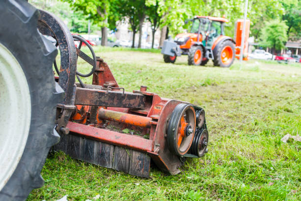 istock Tractor with lawn mowing grass in a Public Park 955083374