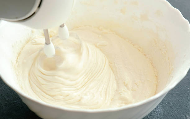 istock Close-up mixer whisk eggs with sugar in a bowl. Cooking apple pie. 955084694