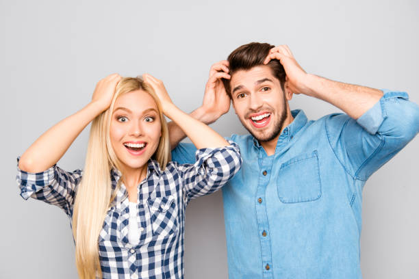 istock Pretty surprising  cheerful couple touching head and opening mouth 955085008