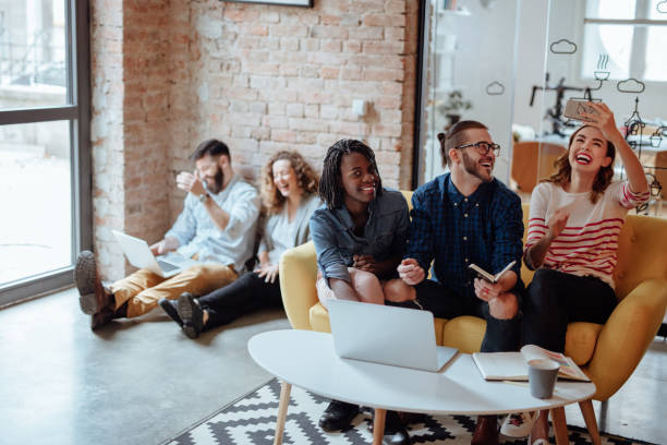 istock Group of people working in a modern office taking selfie 955087770