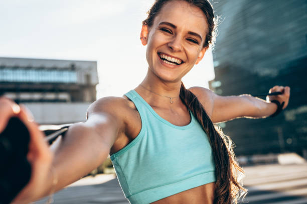istock Smiling woman stretching outdoors 955087788