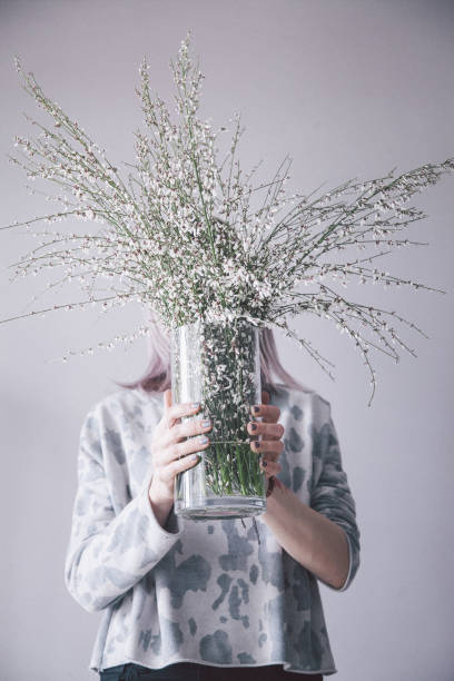 istock Young woman posing with flower 955088092