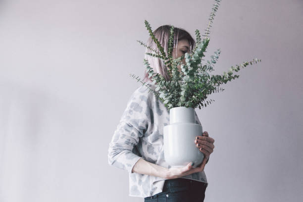 istock Young woman posing with flower 955088154