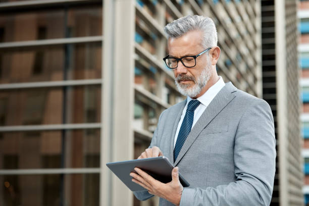 istock Confident businessman with tablet computer in city 955088906