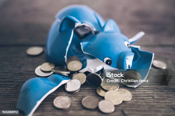 Shattered Broken Piggy Bank With Coins On Rustic Wooden Table Stock Photo - Download Image Now