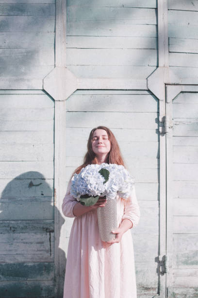 istock Young woman with flower 955091388