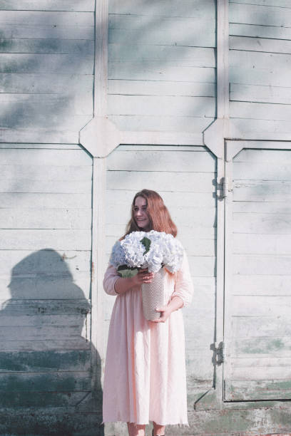 istock Young woman with flower 955091396