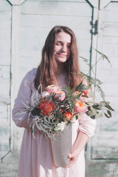 istock Young woman with flower 955091468