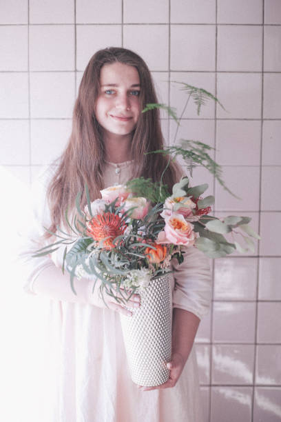 istock Young woman with flower 955091494