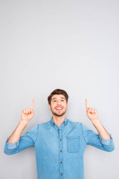 istock Young happy man gesturing with fingers under head 955091840