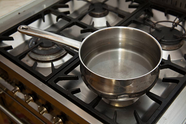 istock pan of water heating on a gas stove. 95509432