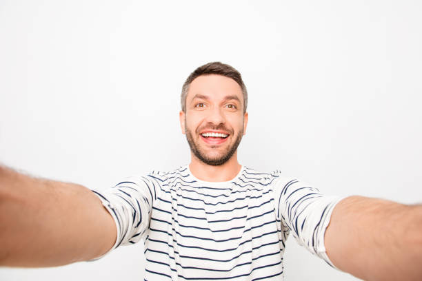 istock Attractive cheerful happy man making selfie 955094946