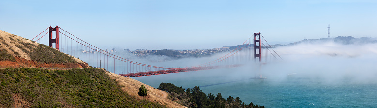 view to the golden gate bridge on a foggy day in summer