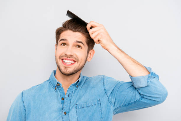 istock Handsome smiling young man doing modern hairstyle 955095502