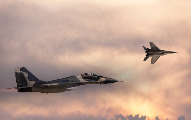 istock Mig-29 Fighter Jets flying at sunset 955097420