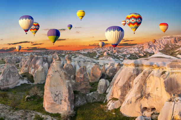 Hot air balloons at sunset over the cave town, Cappadocia, Turkey stock photo