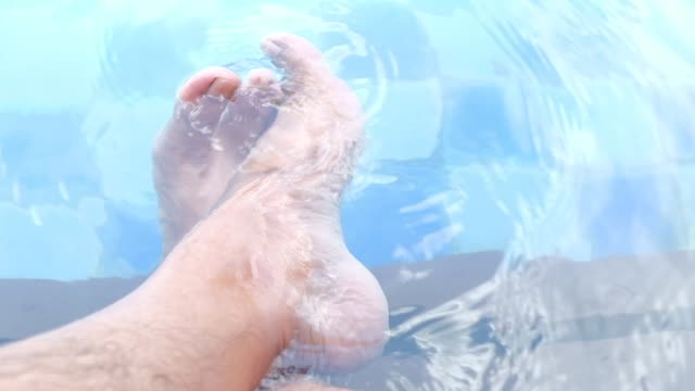 a man feet relax in a hot spring pool