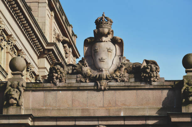 details of art and decor on building of the parliament house of sweden built in neoclassical style, with a centered baroque revival style facade section, located on nearly half of helgeandsholmen island, in the gamla stan, old town district of central sto - sveriges helgeandsholmen imagens e fotografias de stock