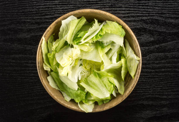 istock Fresh Raw Iceberg Lettuce on black wood 955116780