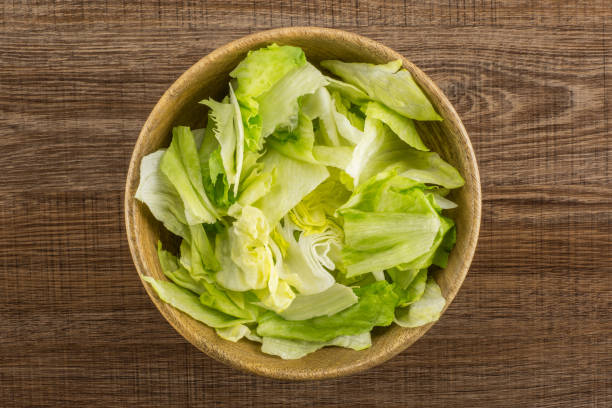 istock Fresh Raw Iceberg Lettuce on brown wood 955116858