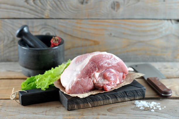 istock piece of raw pork ham on wooden Board 955117344