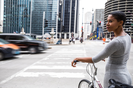 Woman cycling - commuter in downtown Chicago