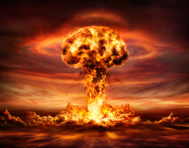Nuclear Bomb Explosion - Mushroom Cloud Nuclear Explosion With Orange Mushroom Cloud nuclear weapon stock pictures, royalty-free photos & images