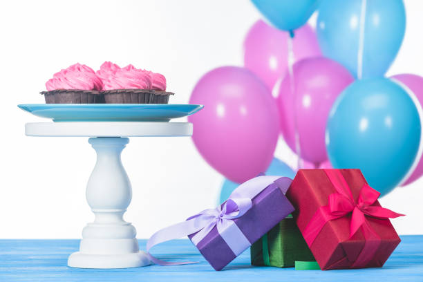 istock gift boxes and cupcakes on cake stand isolated on white 955124130