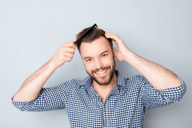 istock Handsome smiling young man doing modern hairstyle 955127350