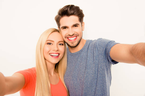 istock Cheerful smiling happy man and woman making selfie 955127664