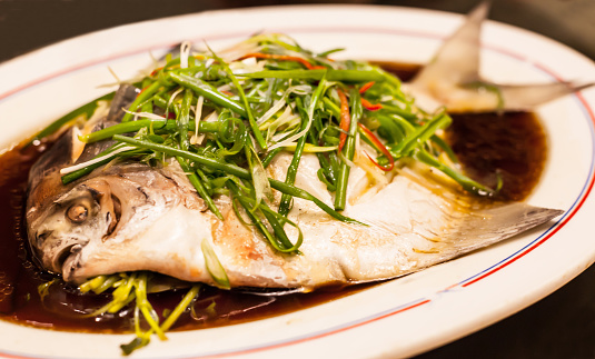 Cooking fried Mackerel fish - food preparation.