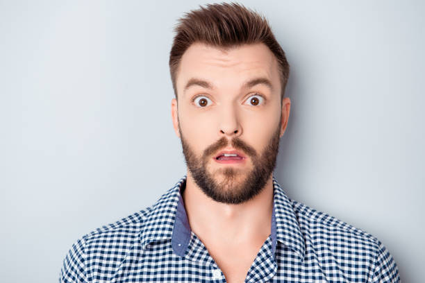 istock Portrait of shocked young bearded guy with open mouth 955131992